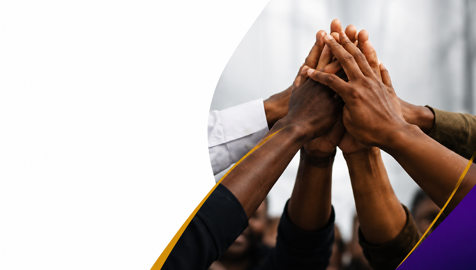 Team members' hands joined together in a huddle